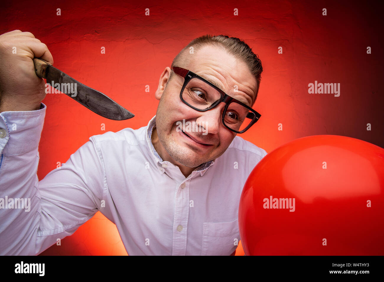 Crazy man going to burst the ballon. Stress concept Stock Photo Alamy