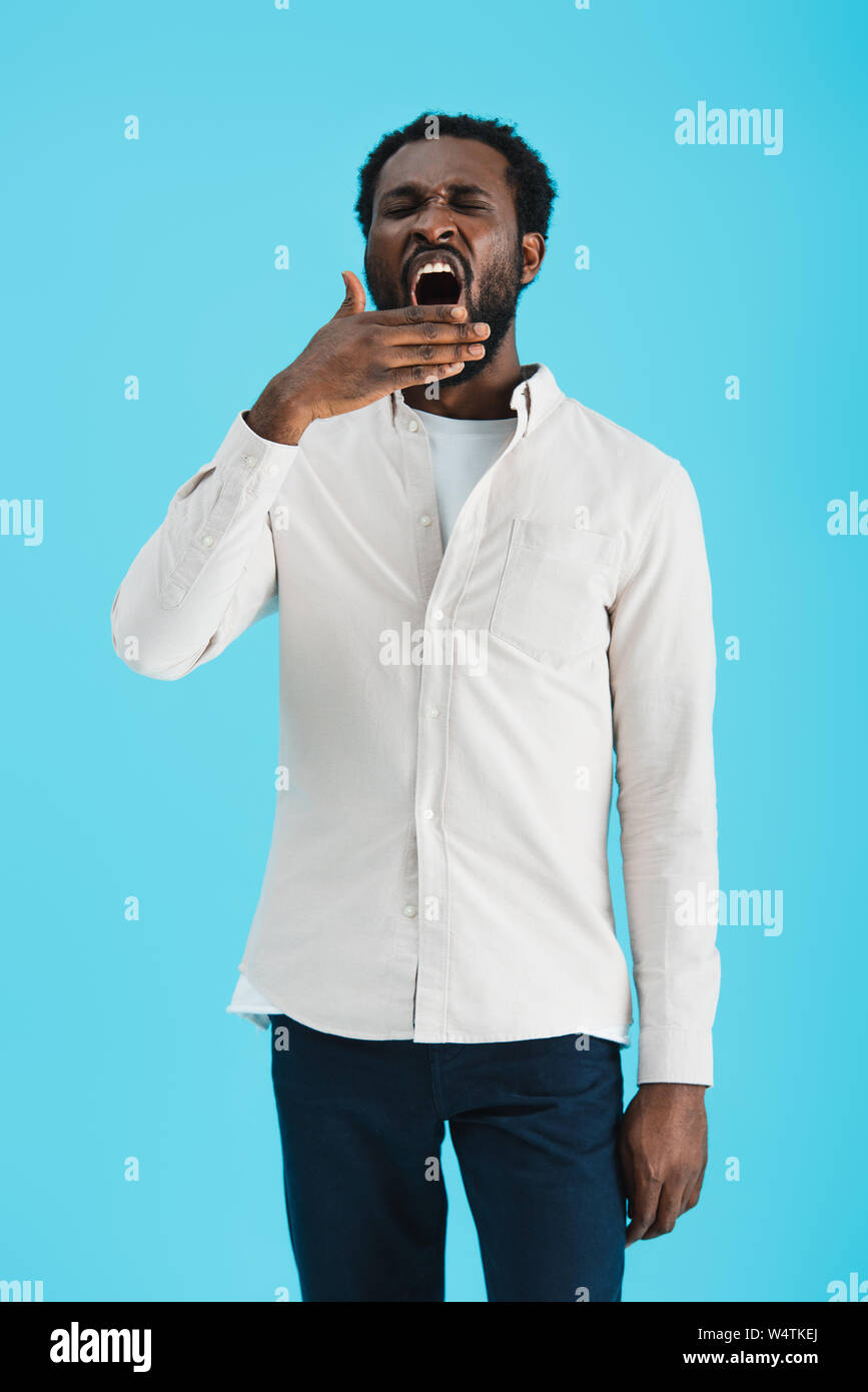 Tired young african man yawning hi-res stock photography and images - Alamy