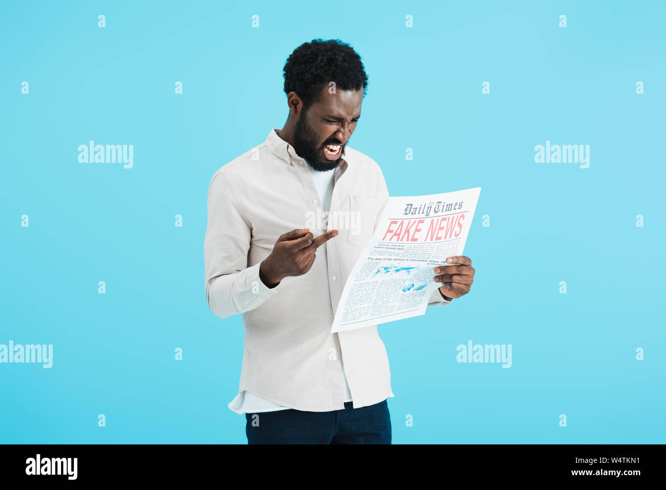 aggressive african american man reading newspaper with fake news and ...