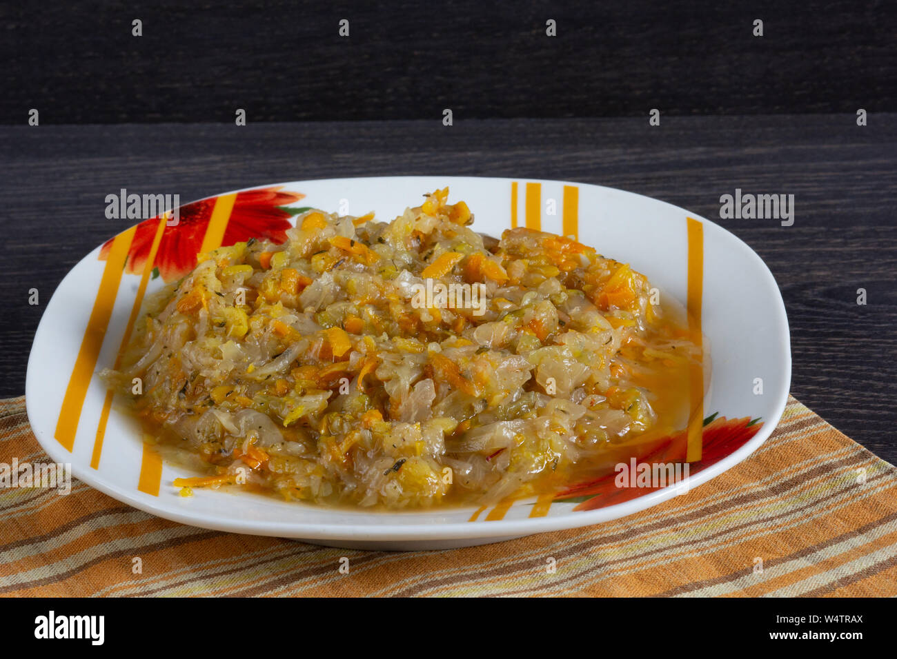 Stewed cabbage with carrot and onion on the plate Stock Photo
