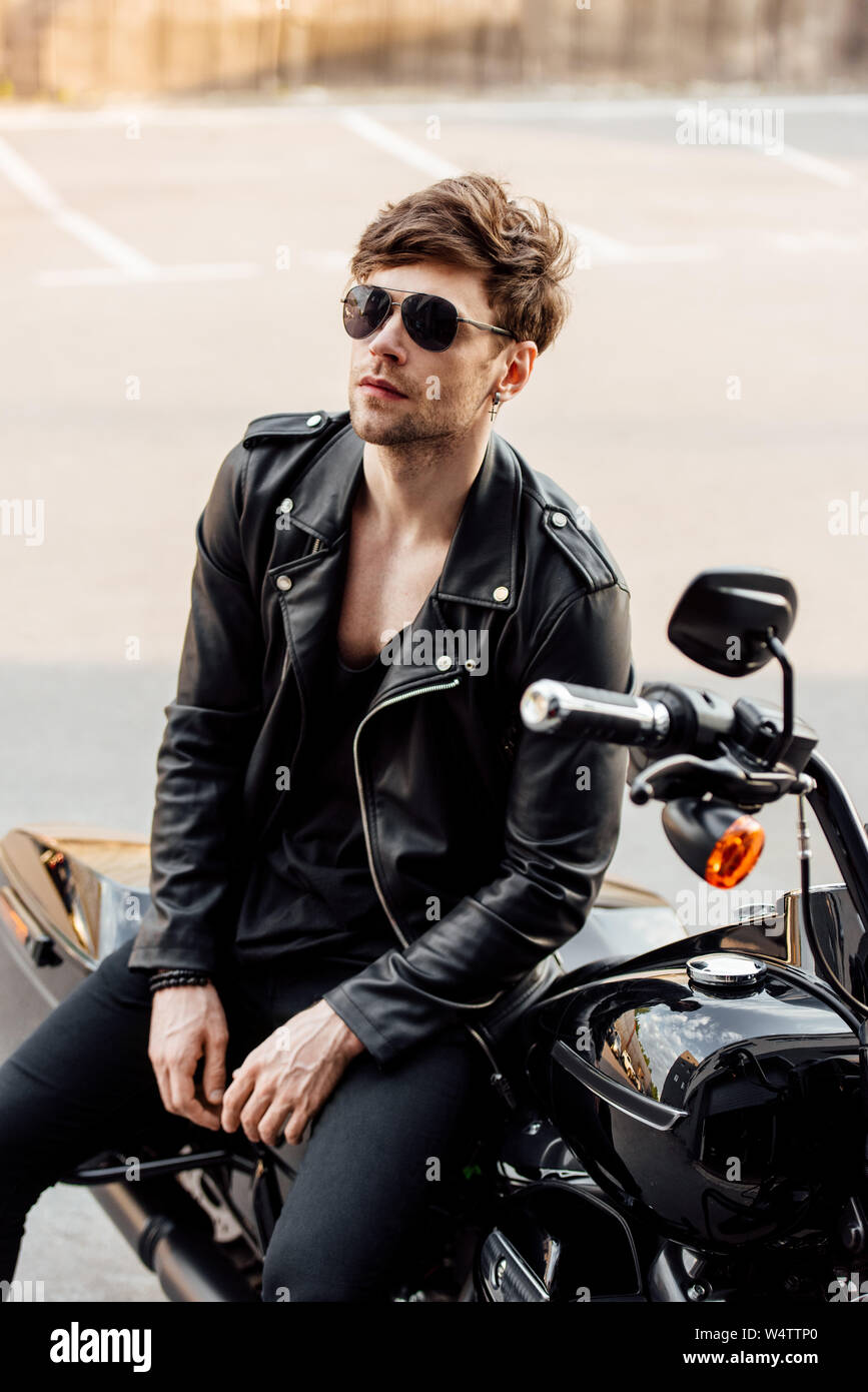 A Man in Black Leather Jacket Sitting Beside the Motorbike · Free Stock  Photo