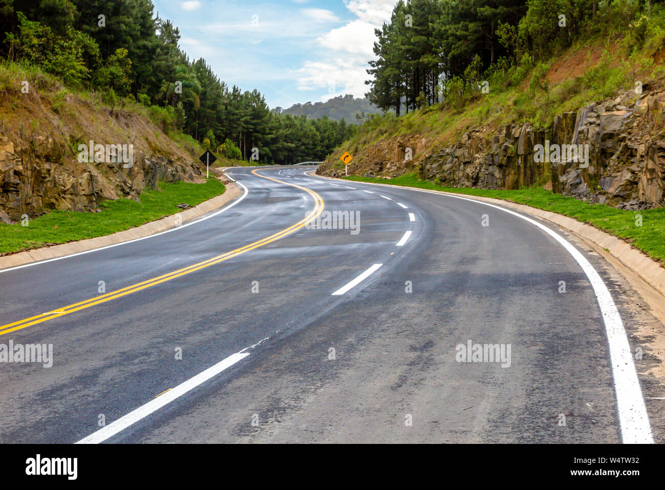 New asphalt road, forest beside, blue sky with clouds Stock Photo - Alamy