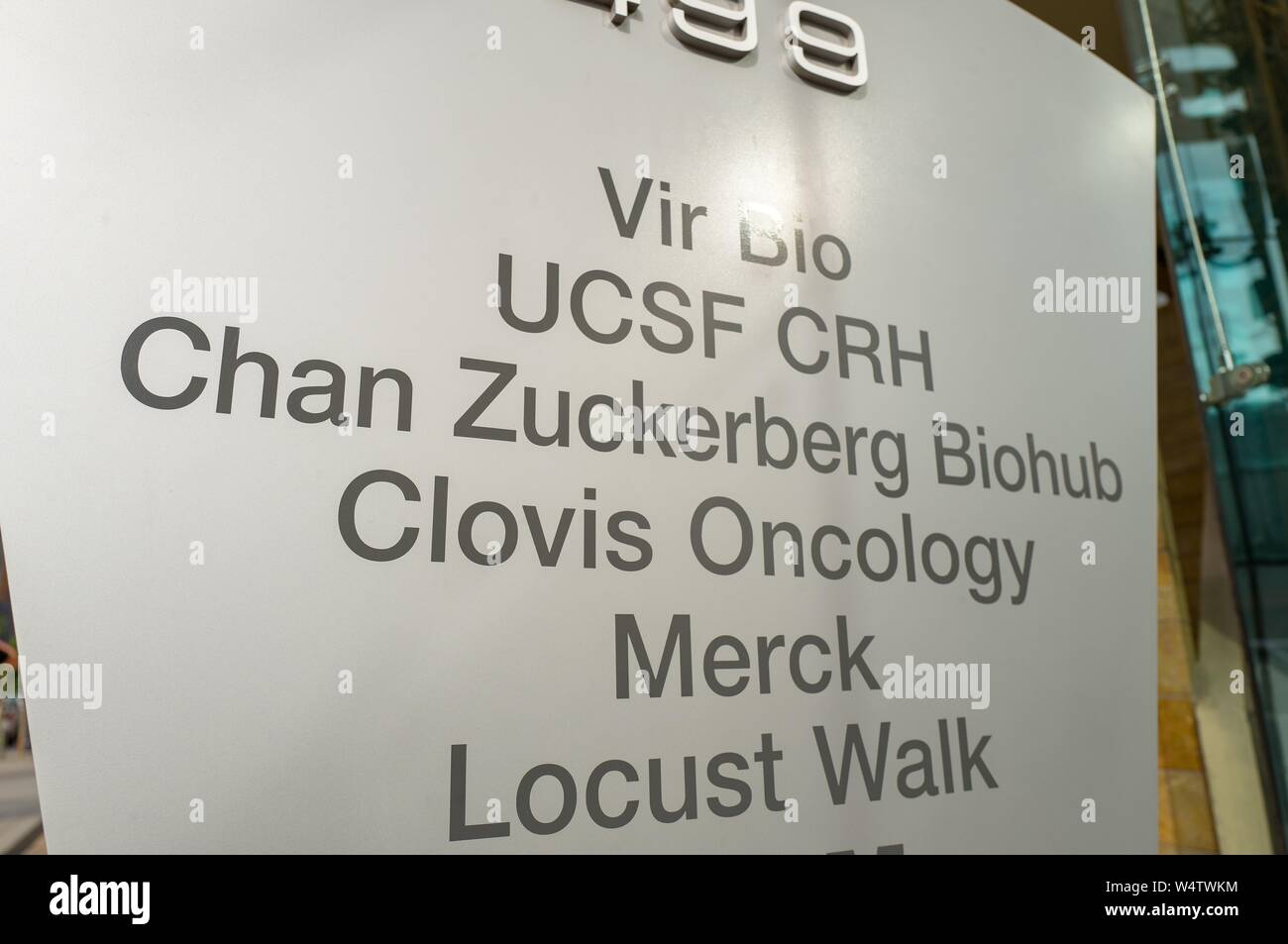 Close-up of sign outside the Chan Zuckerberg Biohub, a life sciences research center sponsored by Facebook founder Mark Zuckerberg, in the Mission Bay neighborhood of San Francisco, California, with logos for Vir Bio, UCSF, Clovis Oncology, Merck and Locust Walk also visible, November 13, 2018. () Stock Photo