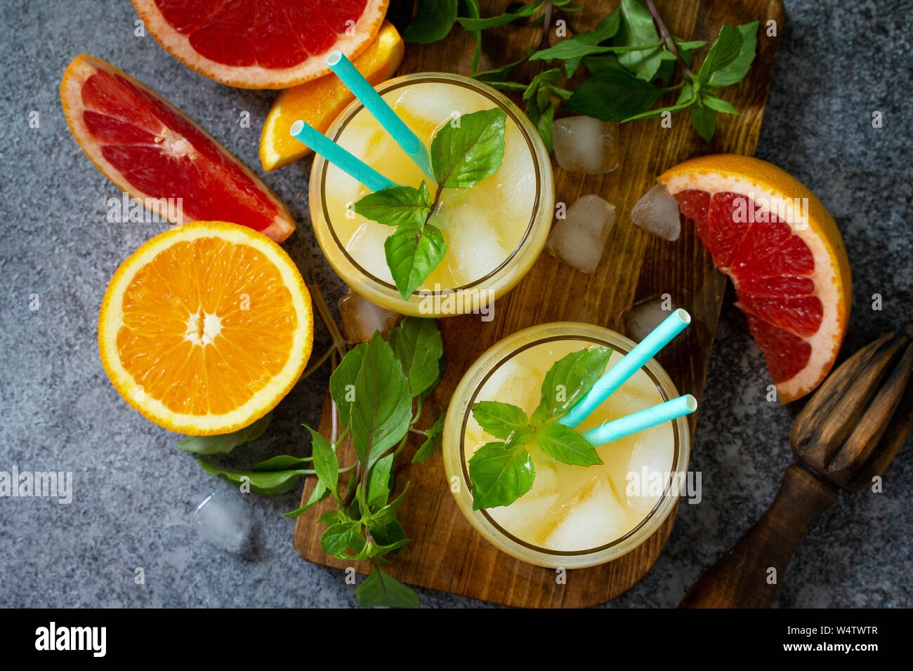 Grapefruit and orange gin cocktail or margarita, refreshing drink with ice. Top view flat lay