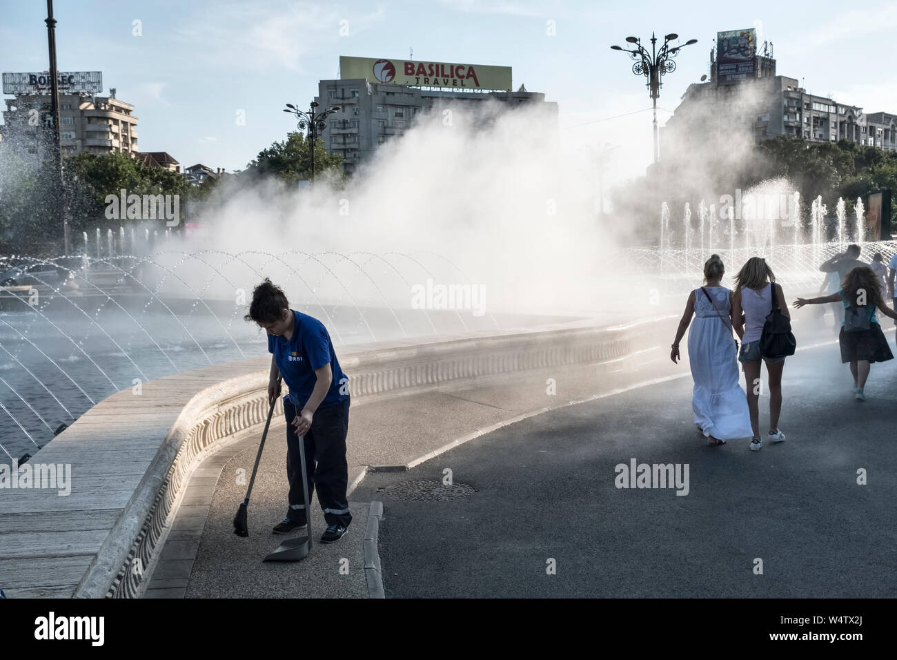 Unirii Square, Bucharest, Romania. As part of the spectacular fountains, a water misting system cools passers-by during the sweltering summer heat Stock Photo