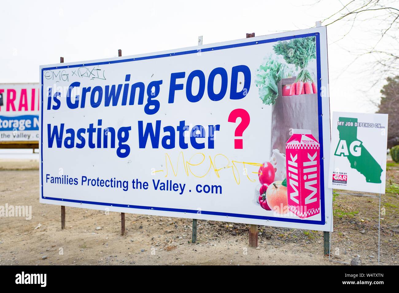 Sign in the San Joaquin Valley of California protesting water politics, with text reading Is Growing Food Wasting Water and an image of various groceries, along the Interstate 5 freeway, created by political group Families Protecting the Valley, December 9, 2018. () Stock Photo