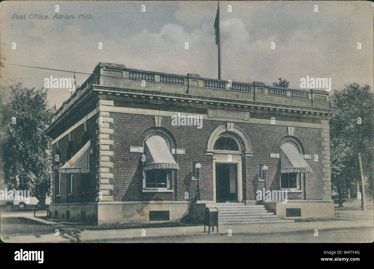 Vintage postcard reproduction of the U.S. Post Office building in Adrian, Michigan, 1930 Stock