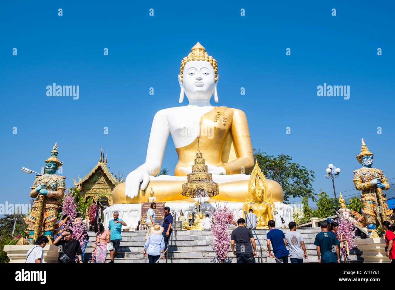 Chiangmai, Thailand - February 24, 2019: View of Thai pilgrimage traveler with 17 Meters tall sitting Buddha at Wat Phra That Doi Kham temple in Chian Stock Photo
