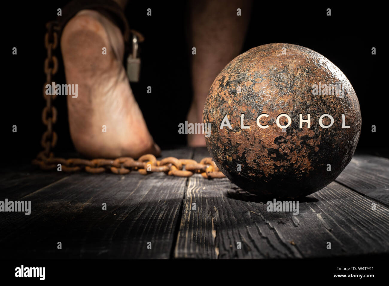 Alcohol are ball on the leg. Concept of alcoholism Stock Photo Alamy