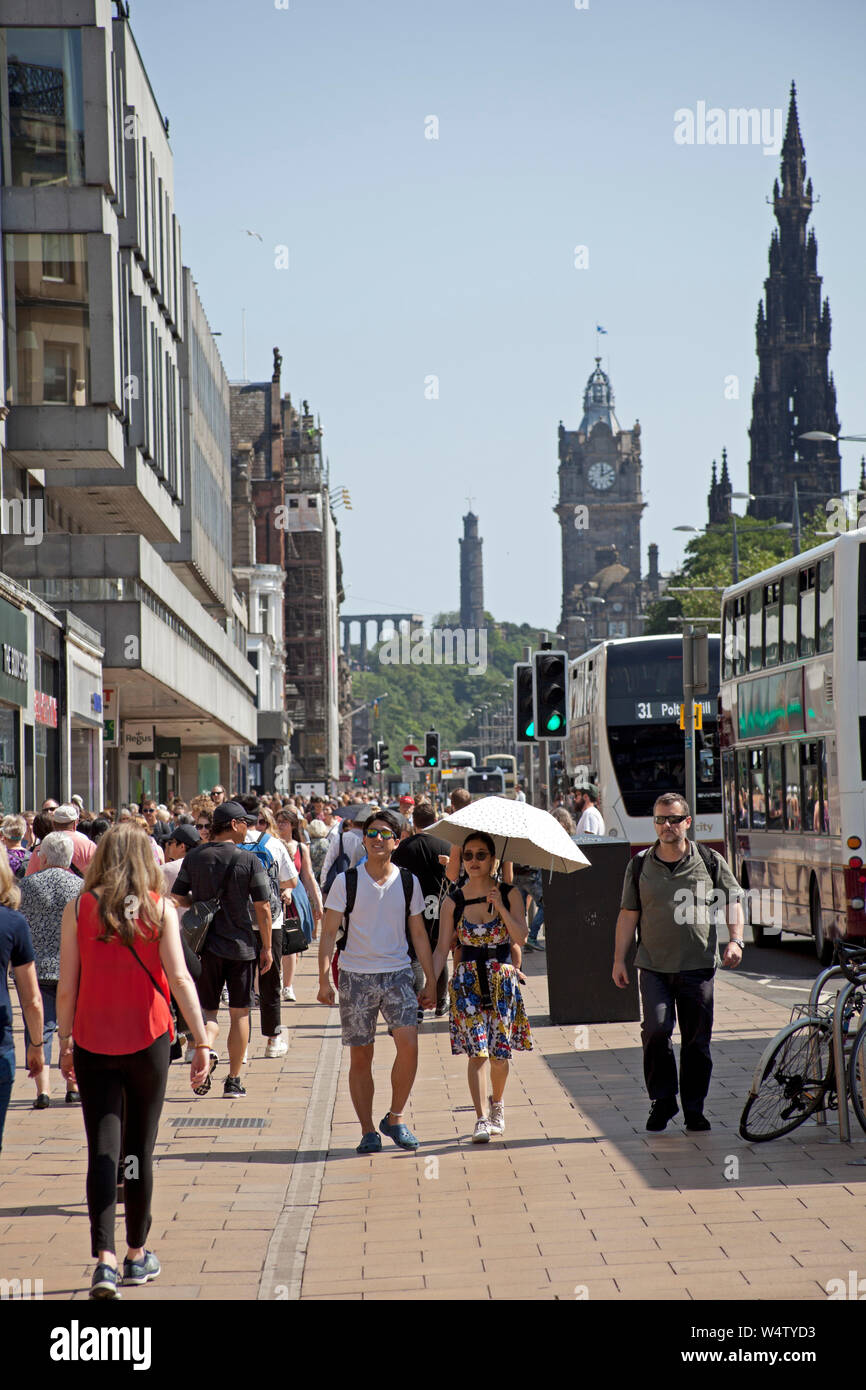 Princes Street Edinburgh Scotland 25th July 2019. Hottest day of the year expected in UK these tourists in the capital city appear to have found it a little hot as the young