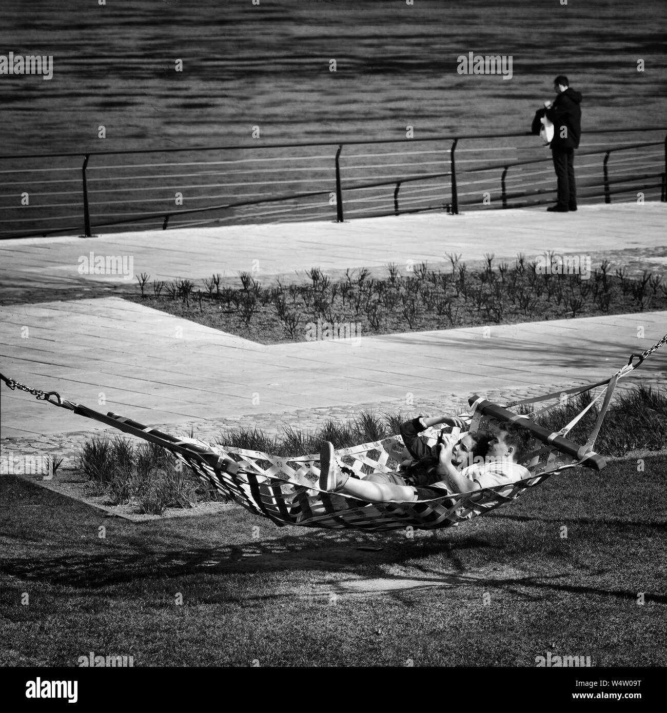 warsaw, Poland. May, 2019. a couple lying on a hammock on the bank of the Vistula River Stock Photo