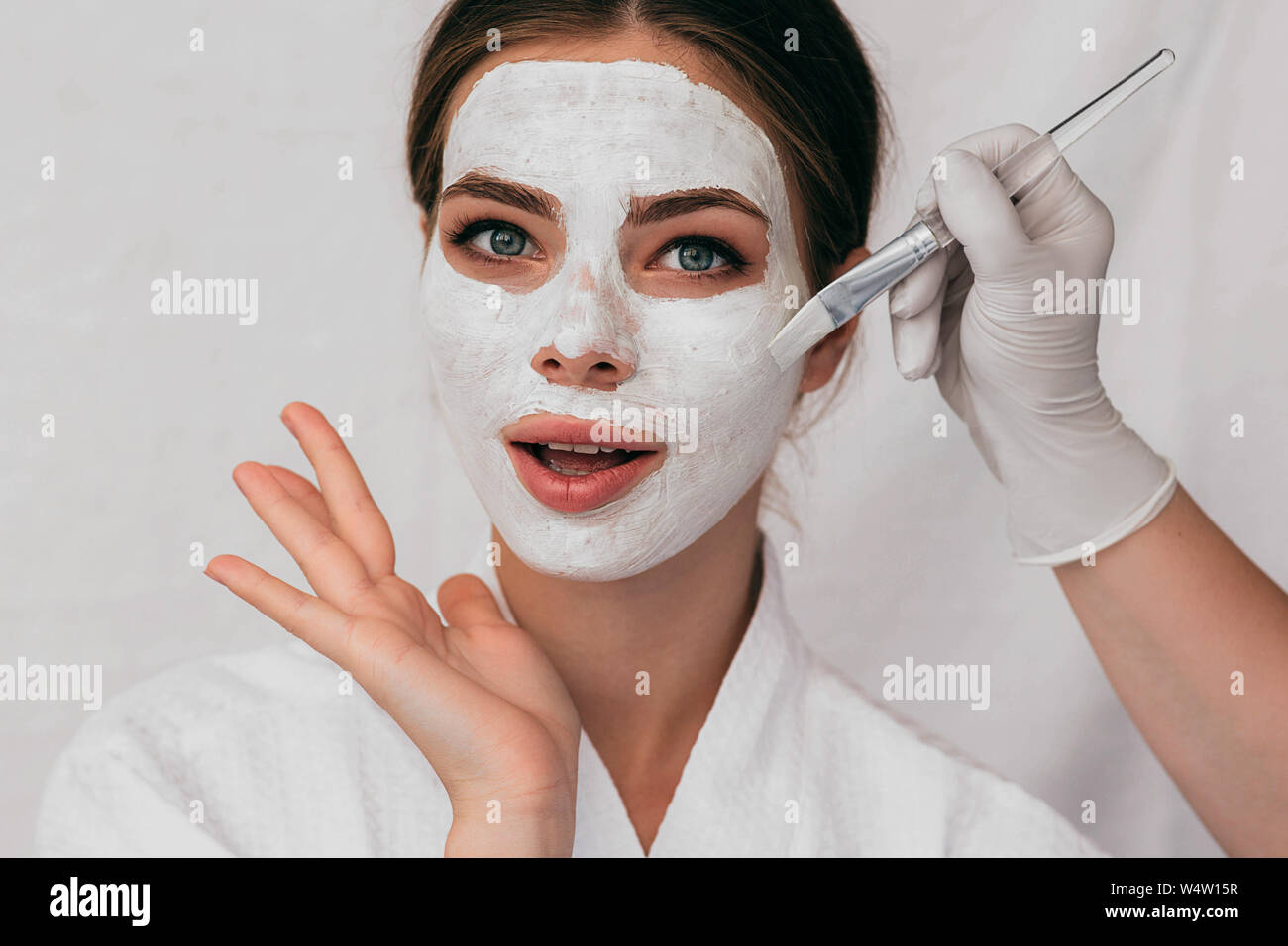 woman with beauty mask on face making surprised face. Wow it is cool beauty mask for moisturizing skin Stock Photo