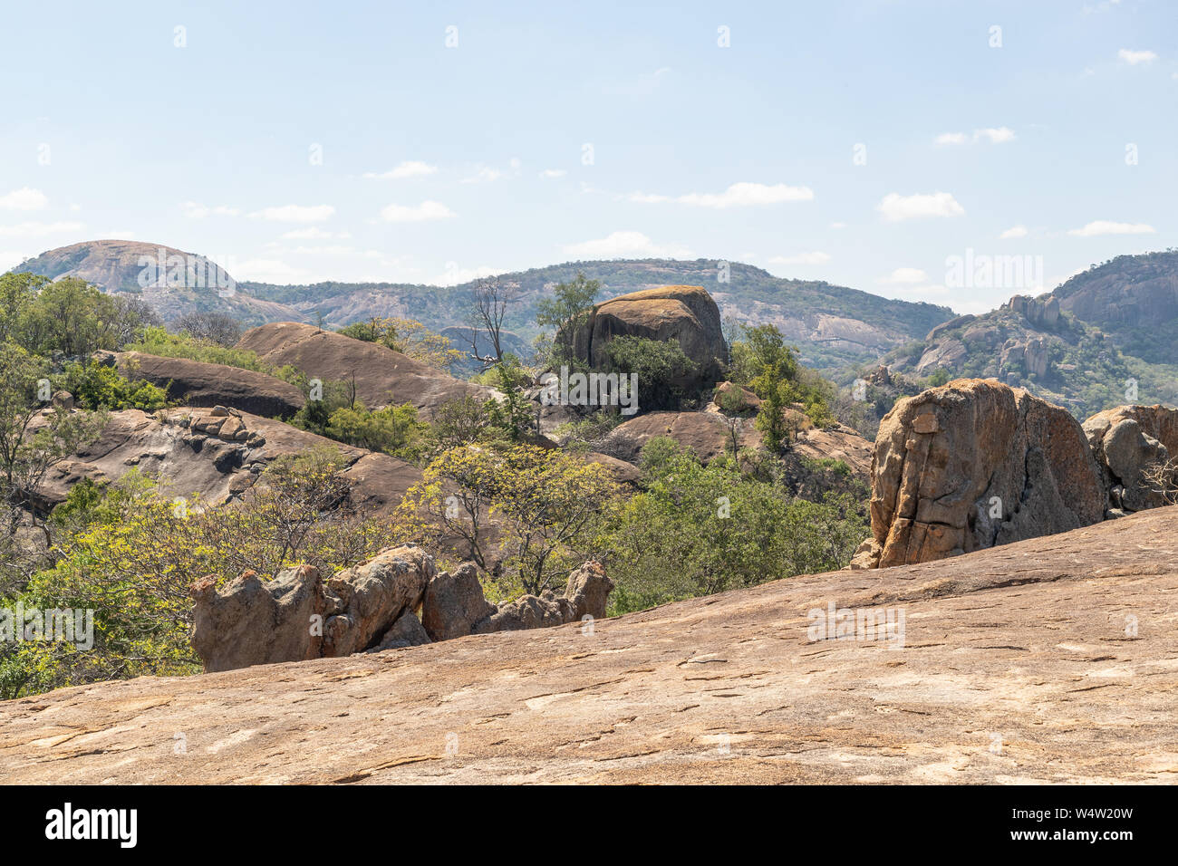 A view of a collection of boulders from the top of another rock formation. Stock Photo