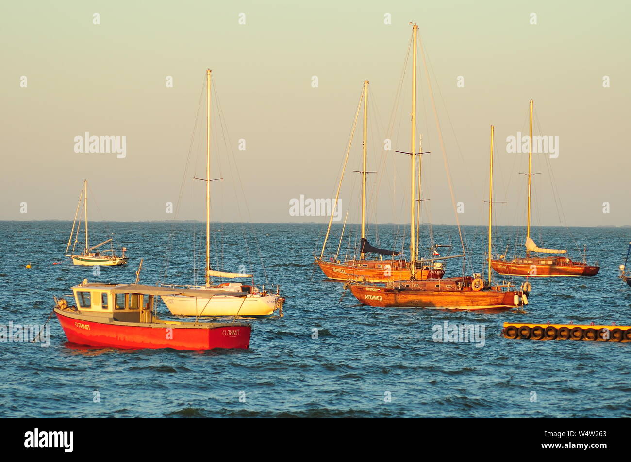 Yachts and boats at sunset at sea Stock Photo - Alamy