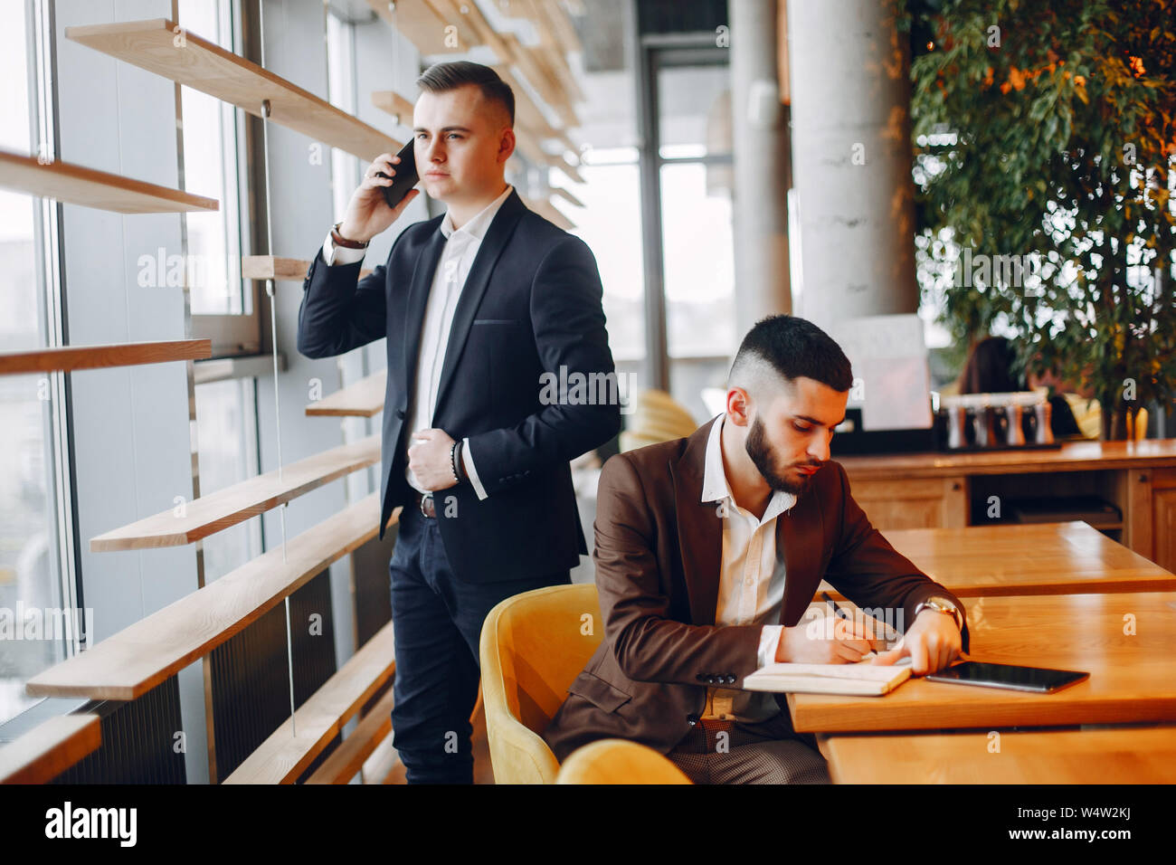 Two businessmen working in a cafe Stock Photo