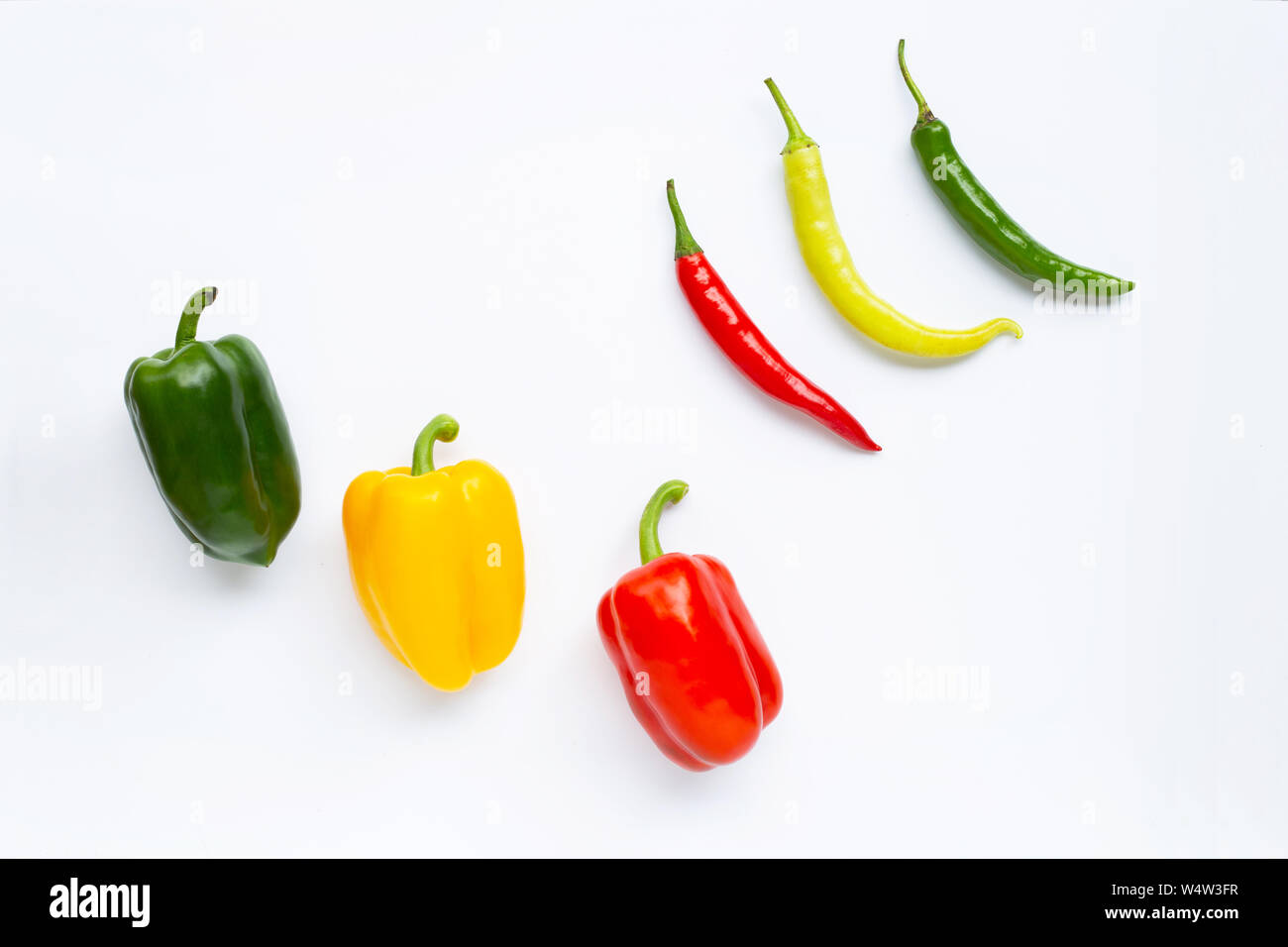 Different colors bell pepper and chili peppers isolated on white