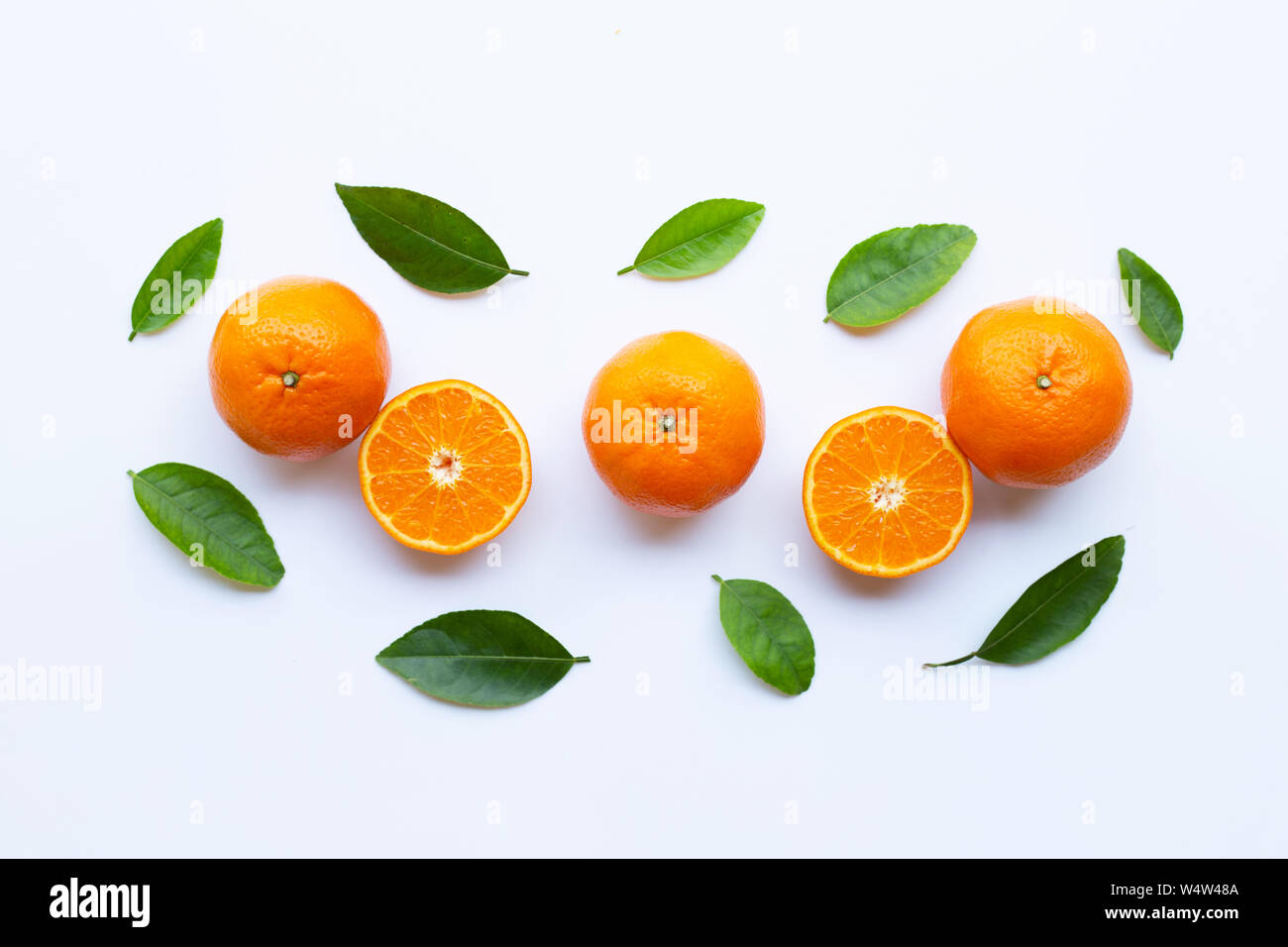 High vitamin C. Fresh orange citrus fruit with leaves isolated on white