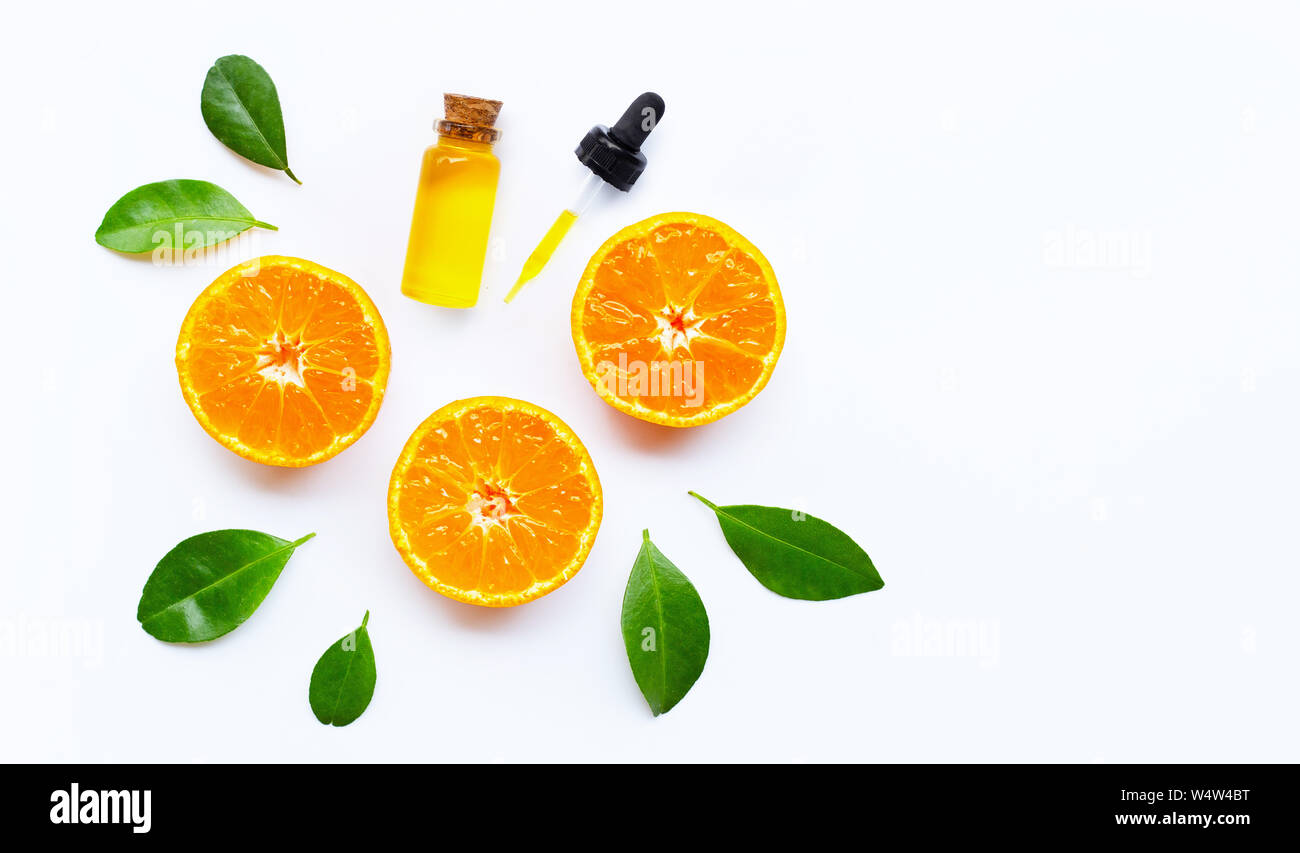Essential oil with oranges on white background. Stock Photo