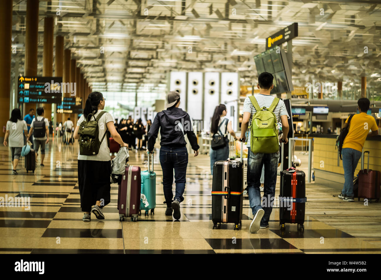 Singapore - April 4,2018: Travellers proceed to check in their luggage at T3 Changi International Airport departure hall. Stock Photo