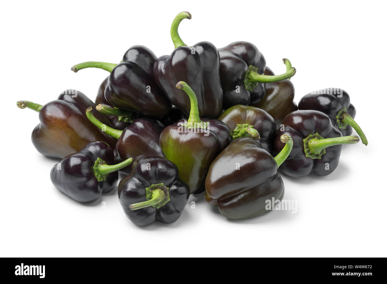 Heap of fresh raw mini purple bell peppers isolated on white background Stock Photo