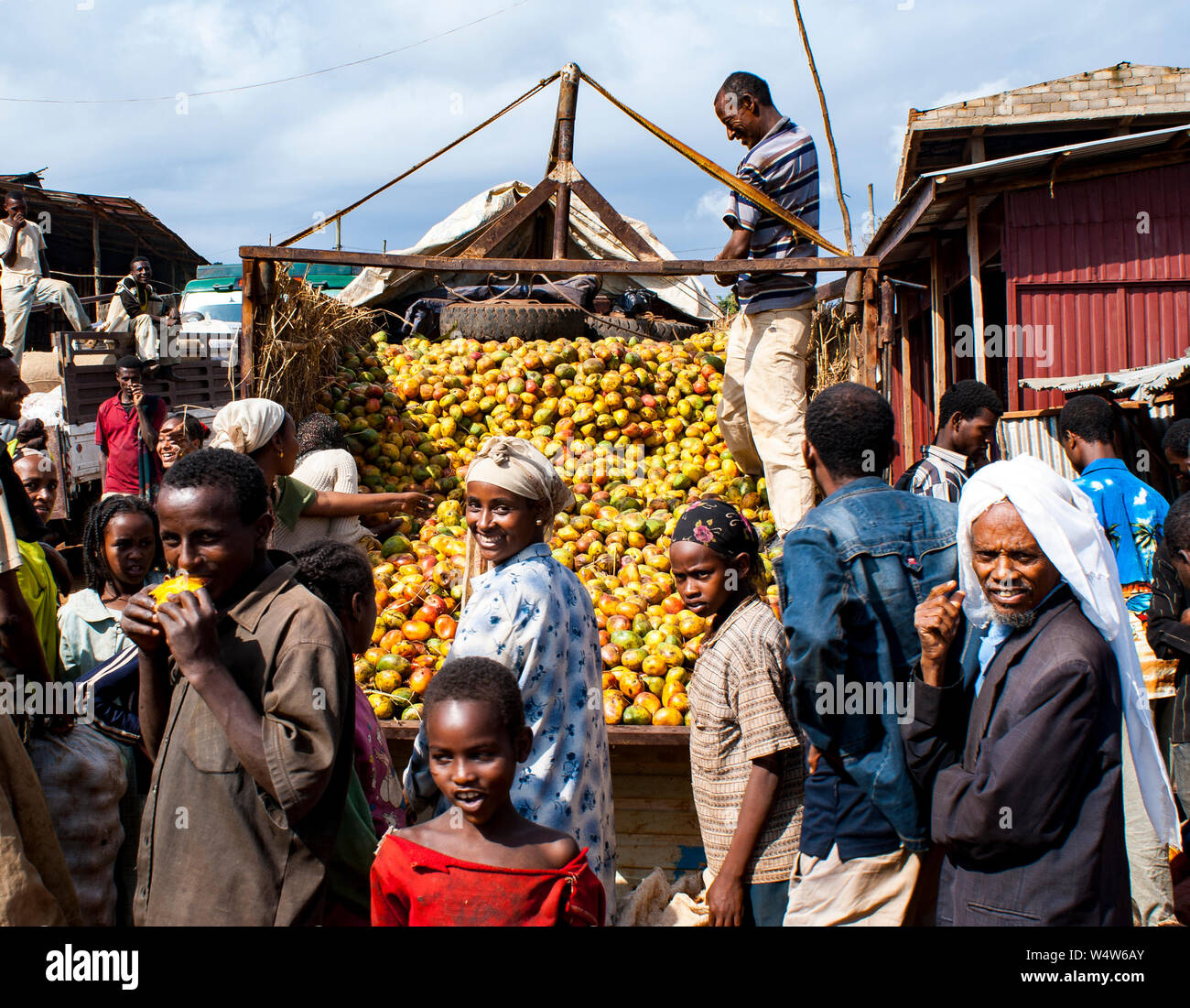 Lorry selling mangoes surrounded by people in a rural market in Illubabor, Ethiopia Stock Photo