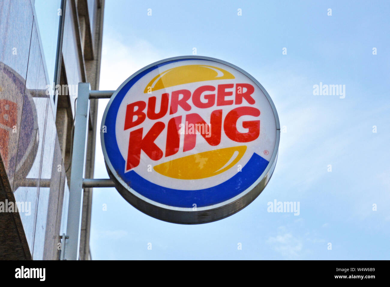 Mannheim, Germany - July 2019: Logo of burger fast food chain 'Burger King' hanging outside in front of blue sky Stock Photo