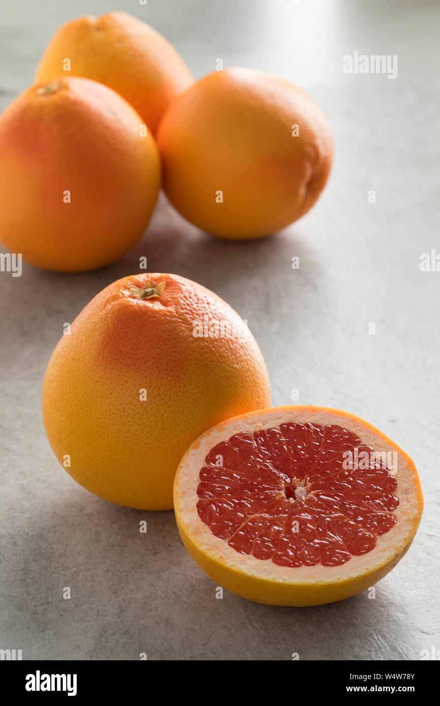 Whole and halved fresh juicy red grapefruit Stock Photo