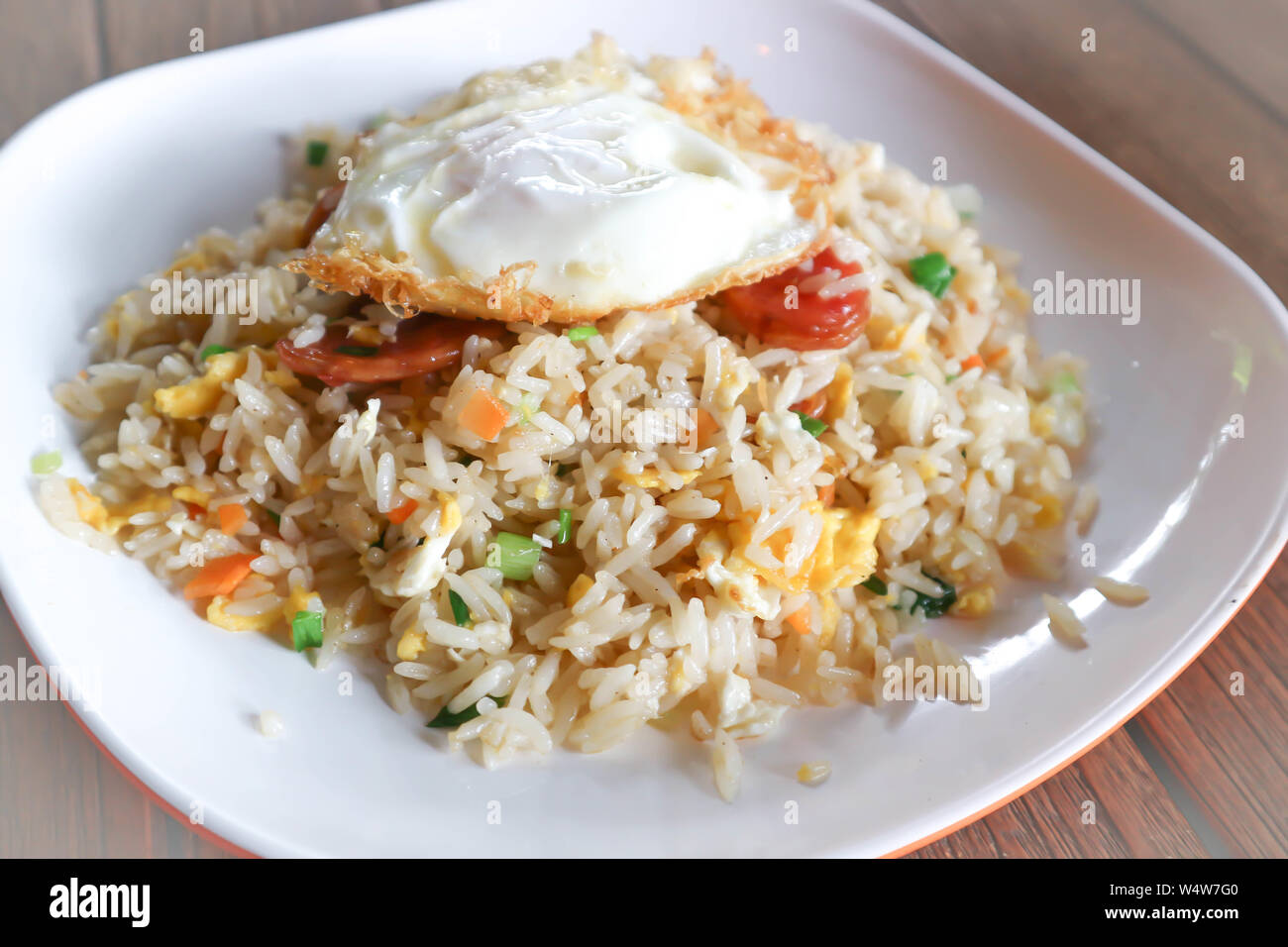 stir-fried rice with deep fried sausage ,egg and vegetable Stock Photo