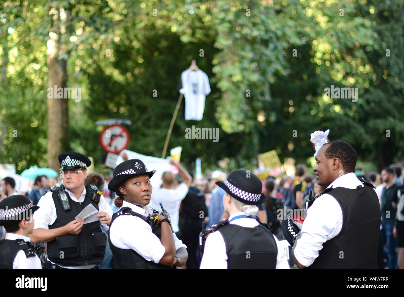 Pensive police-officers survey the scene at the fringes of the anti-Boris protest Stock Photo