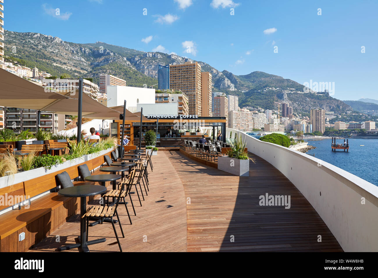 MONTE CARLO, MONACO - AUGUST 21, 2016: Starbucks Coffee cafe terrace in a sunny summer day with sea and city view in Monte Carlo, Monaco. Stock Photo