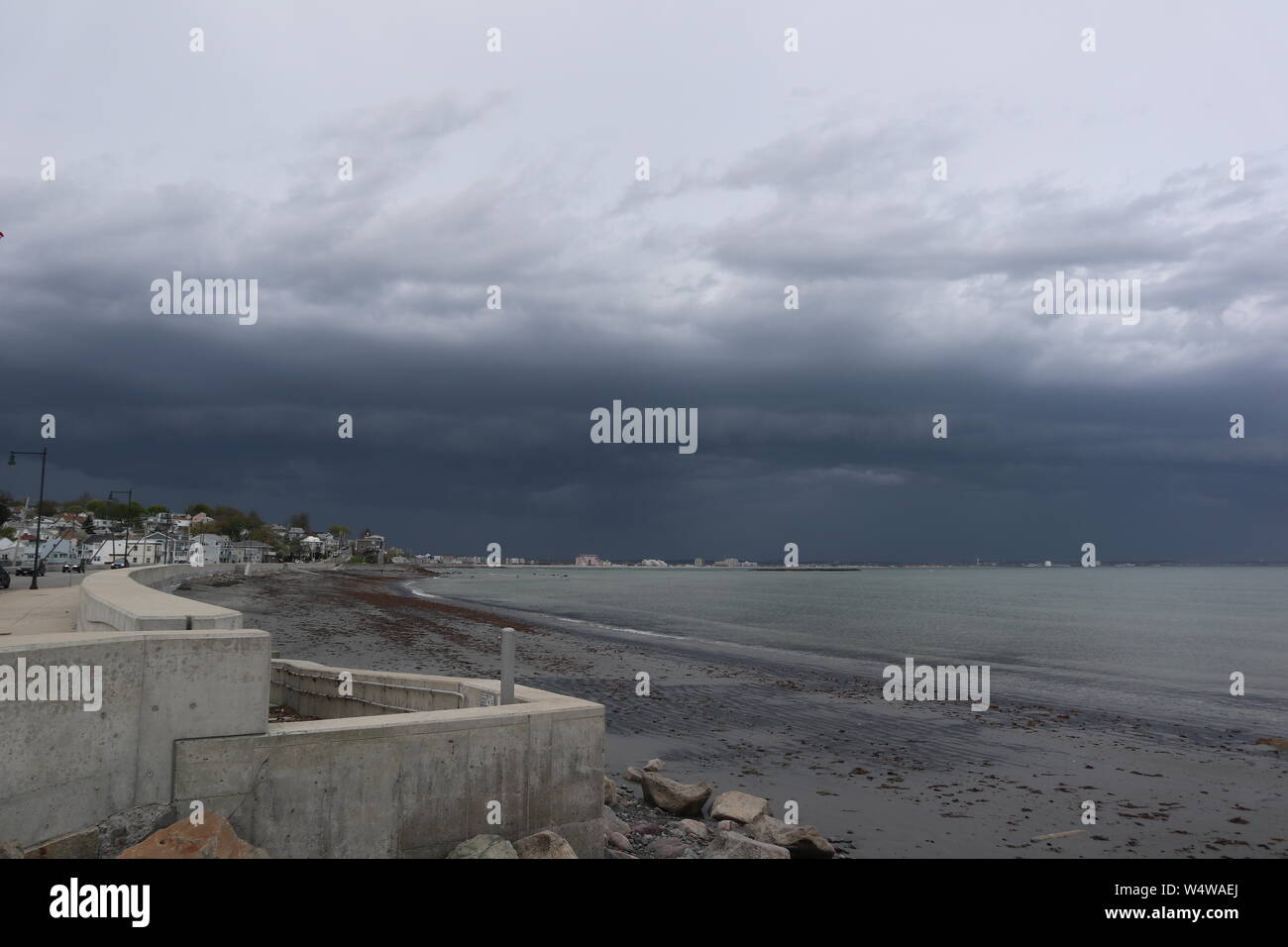 Dark Clouds Rolling Over Beach Stock Photo