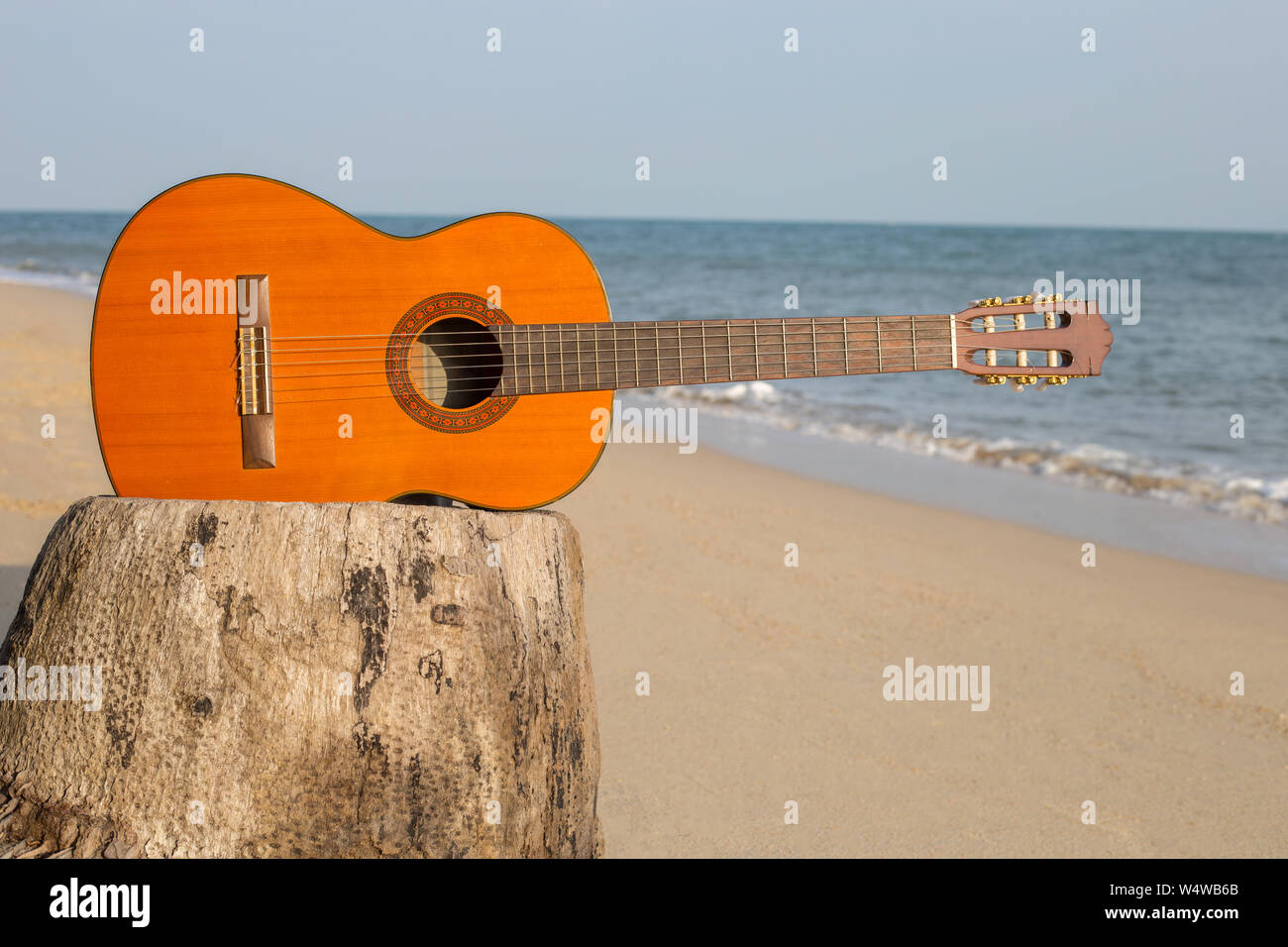 Guitar on sand beach In the beautiful sea summer Stock Photo