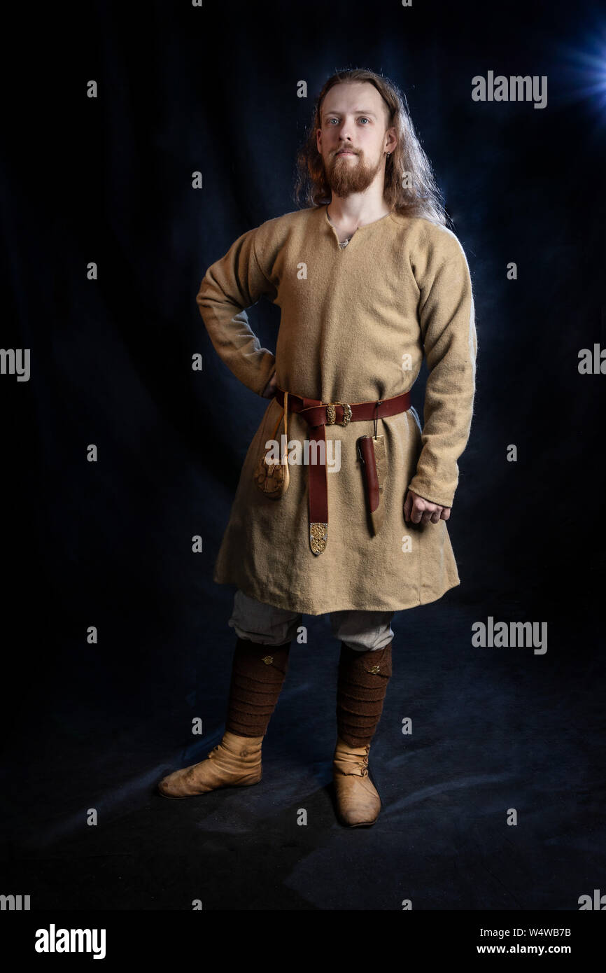 young red-haired viking man in everyday costume of the early Middle Ages, hobby, historical reconstruction Stock Photo