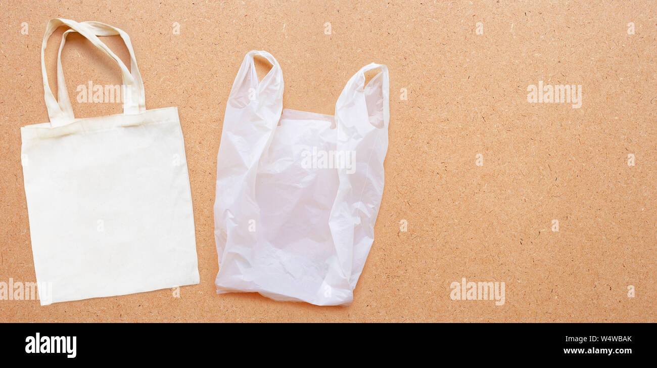 White fabric bag with white plastic bag on plywood background. Copy space Stock Photo Alamy