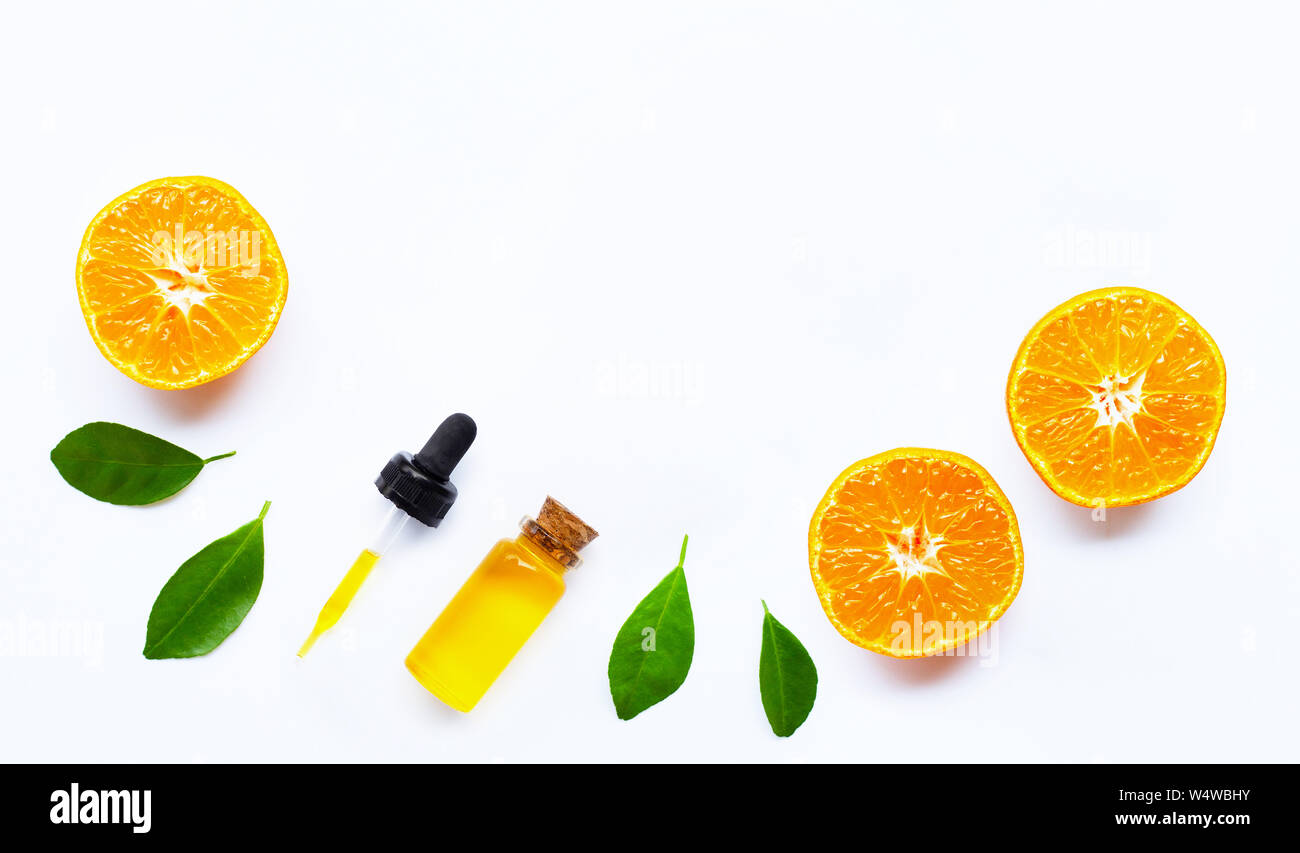 Essential oil with oranges on white background. Stock Photo