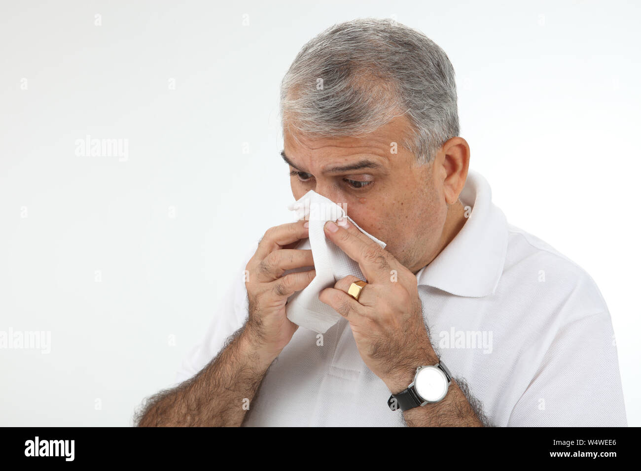 Old man blowing nose with handkerchief Stock Photo Alamy