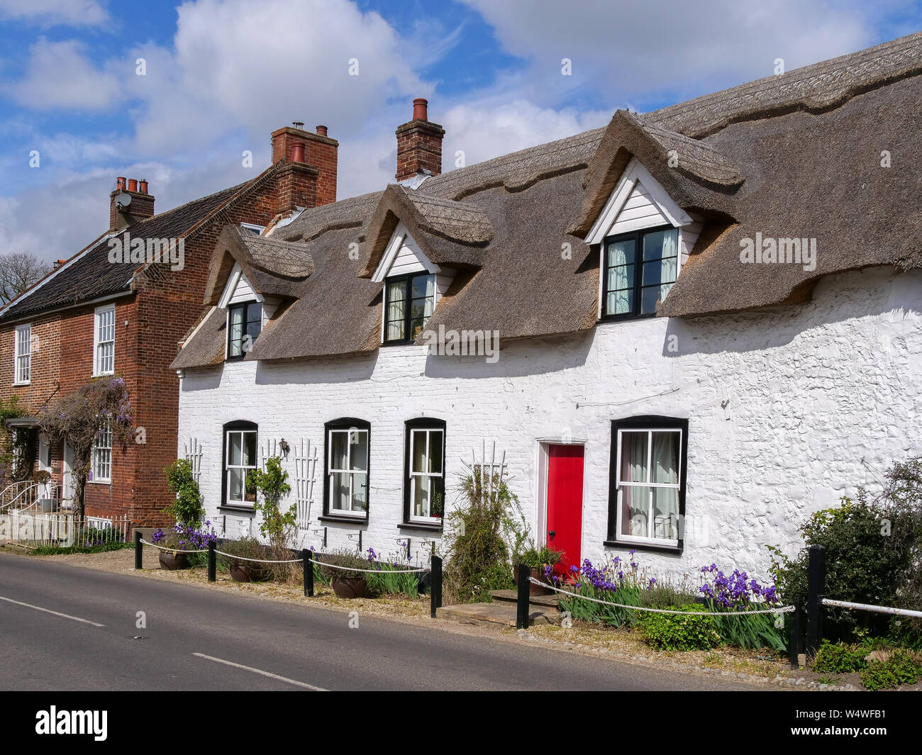 Traditional thatched cottages in Ludham, Norfolk. A classic old English tea room at the end of the row. Stock Photo