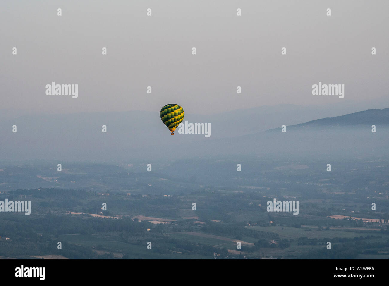 Hot air balloon ride over Tuscany valley Stock Photo