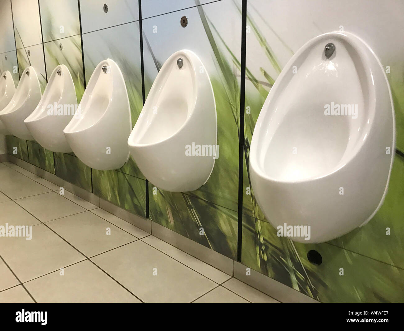 Mens restroom or toilet urinals Stock Photo Alamy