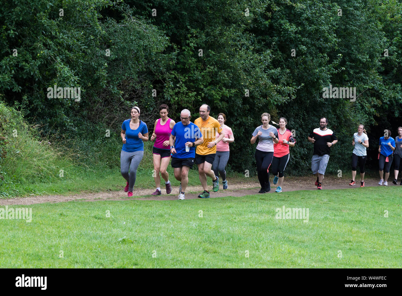 People running in parkrun to keep fit Stock Photo