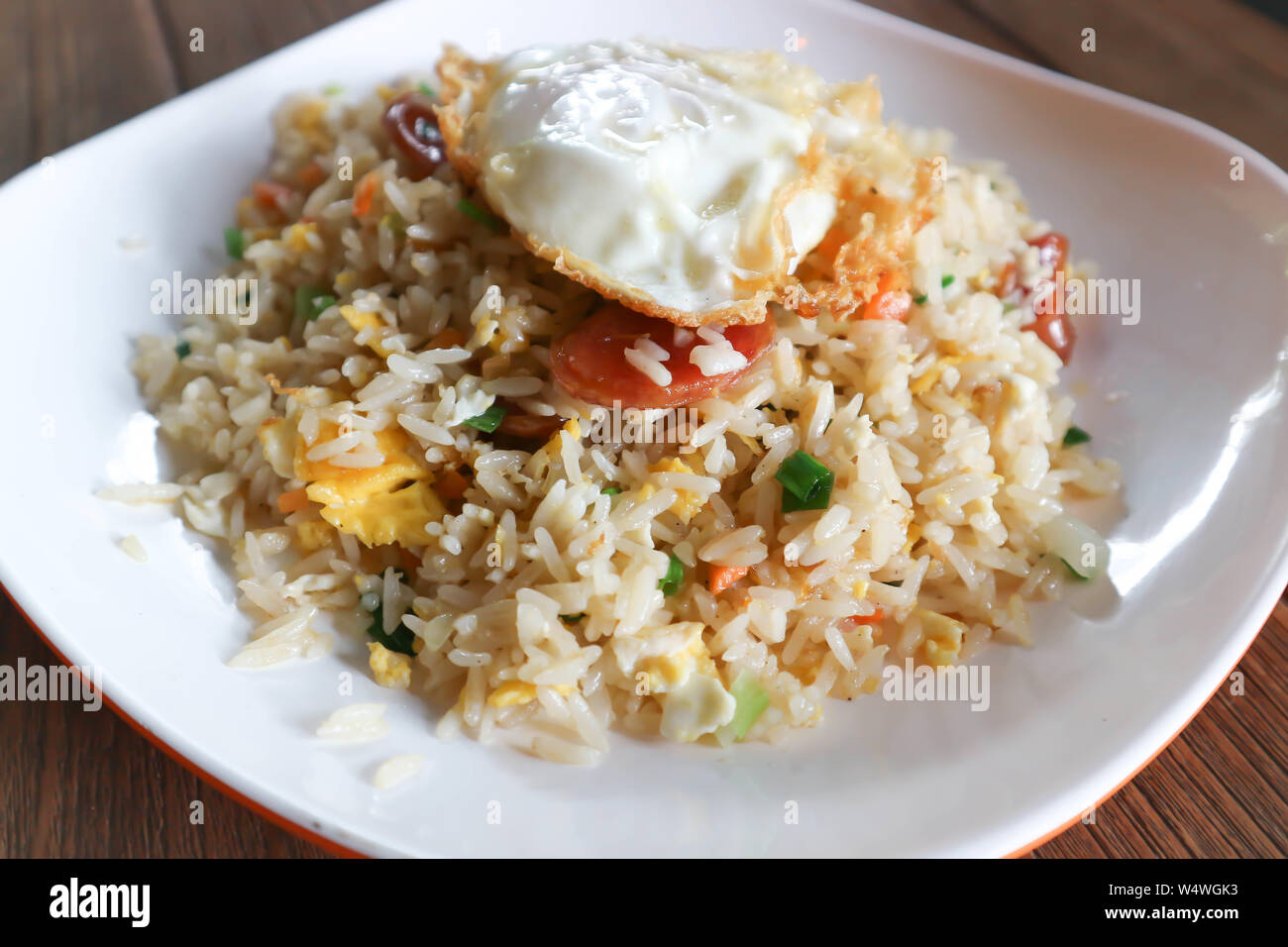 stir-fried rice with deep fried sausage ,egg and vegetable Stock Photo