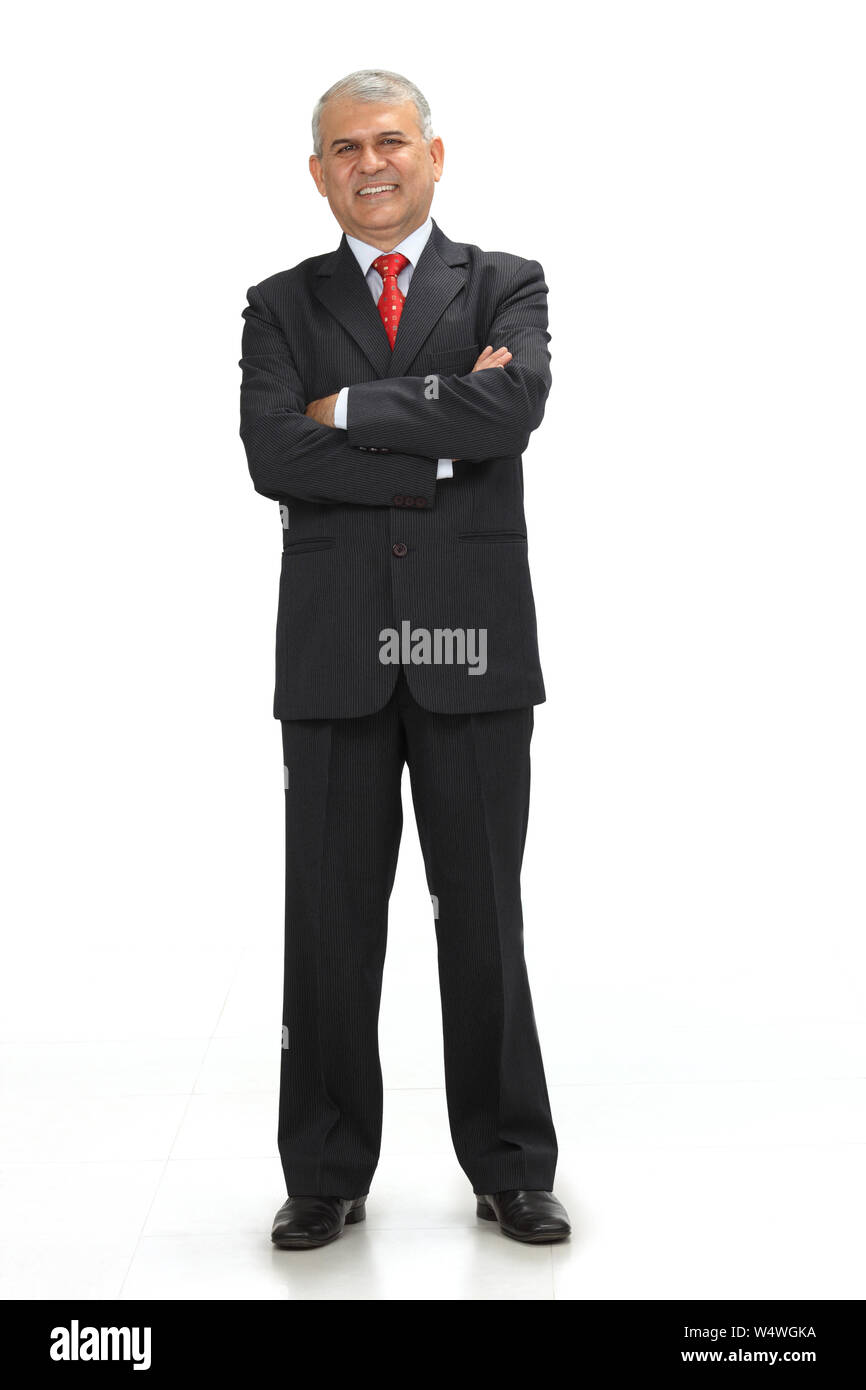 Businessman smiling with his arms crossed Stock Photo