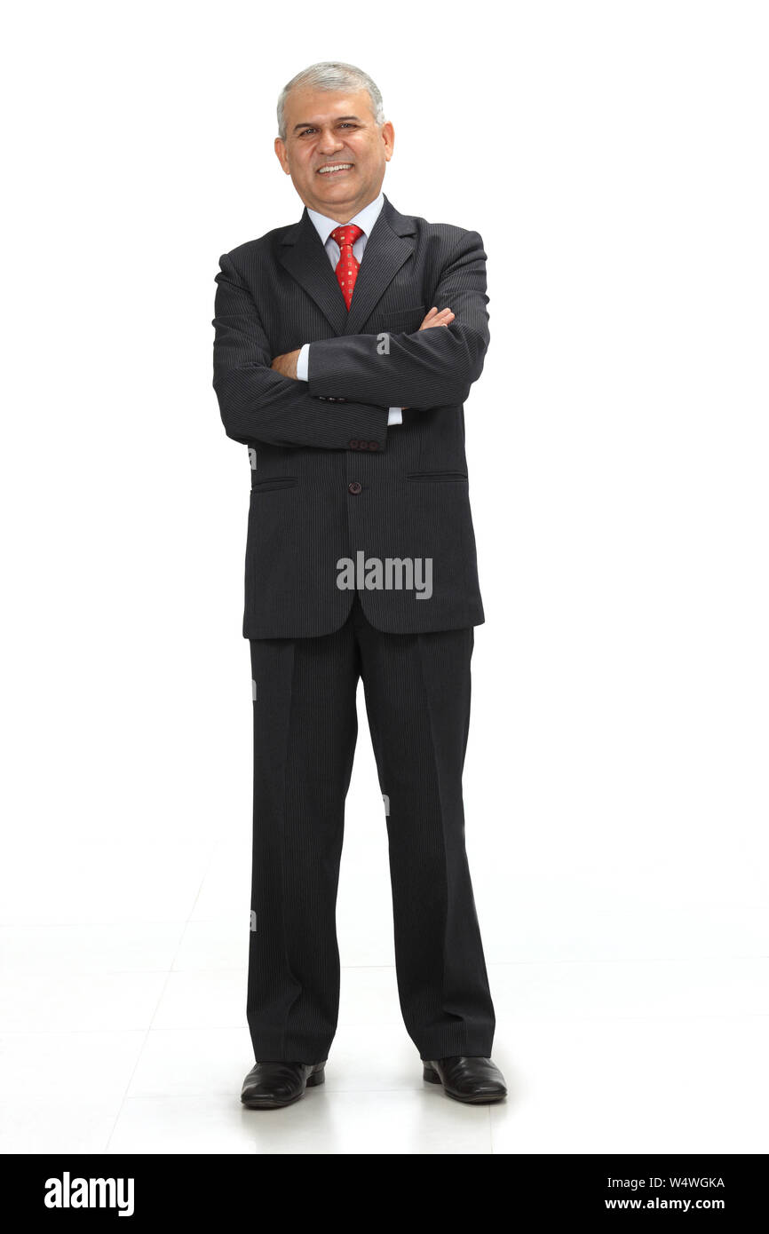 Businessman smiling with his arms crossed Stock Photo - Alamy