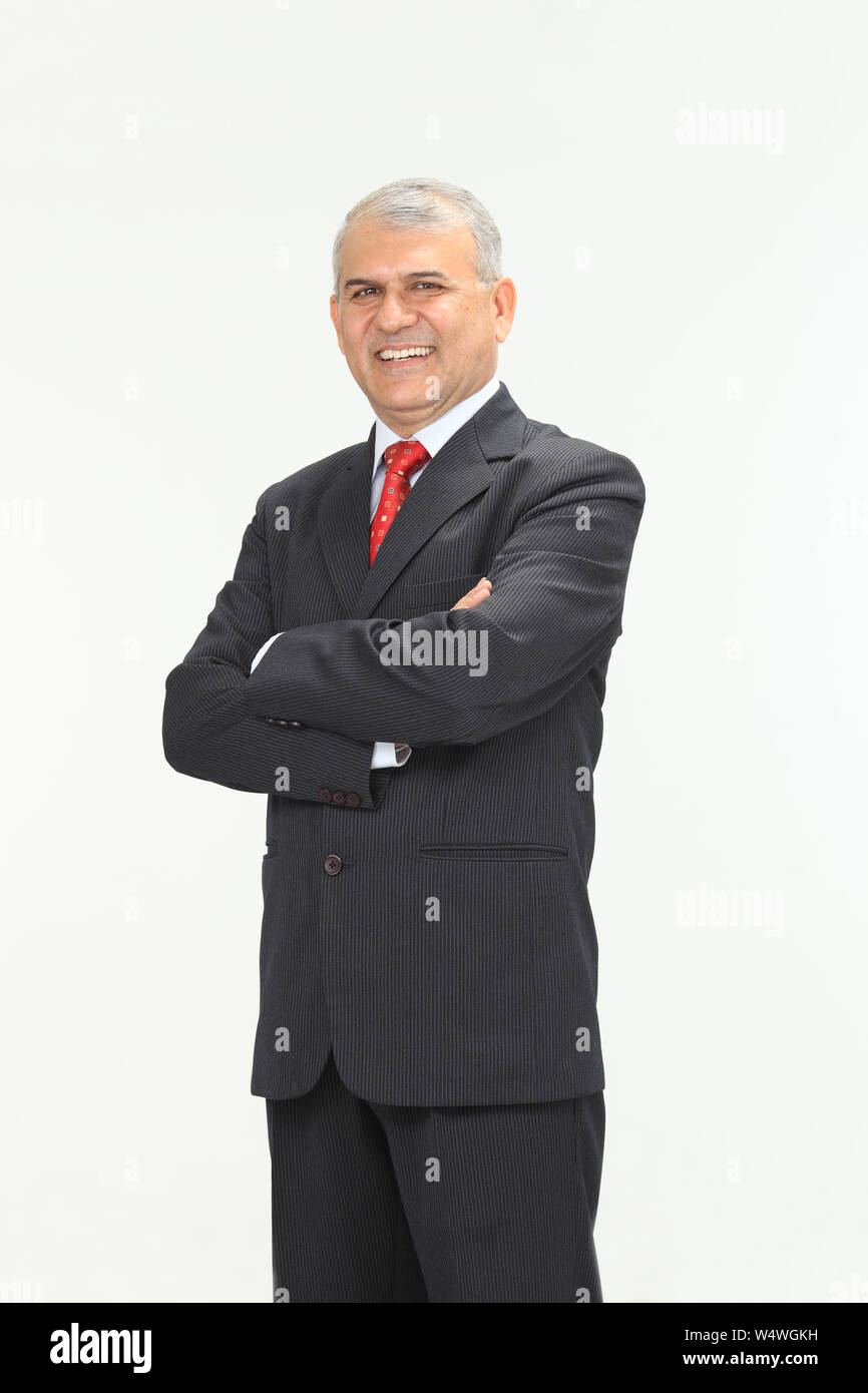 Businessman smiling with his arms crossed Stock Photo - Alamy
