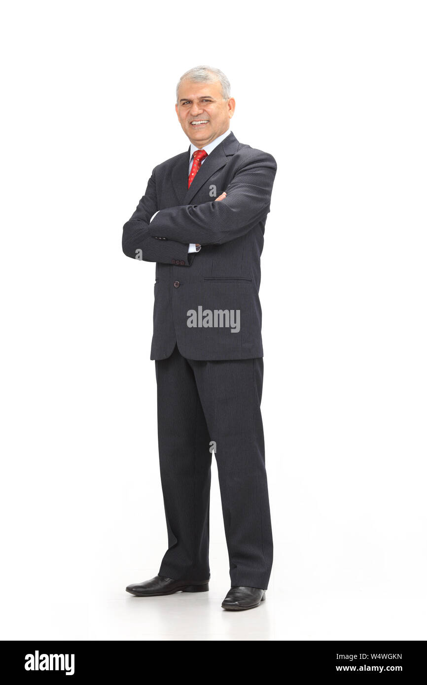 Businessman smiling with his arms crossed Stock Photo - Alamy
