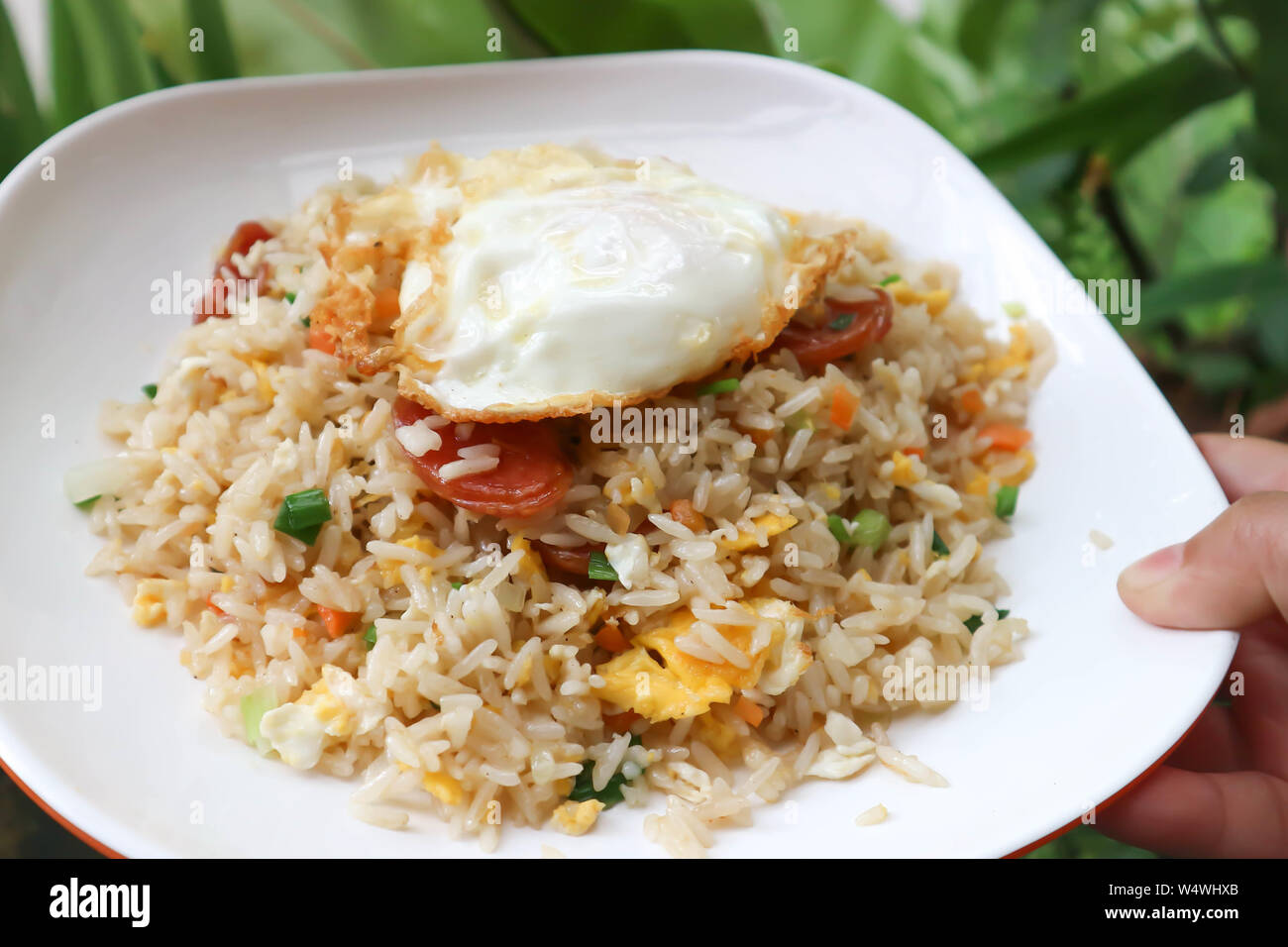 stir-fried rice with deep fried sausage and egg Stock Photo