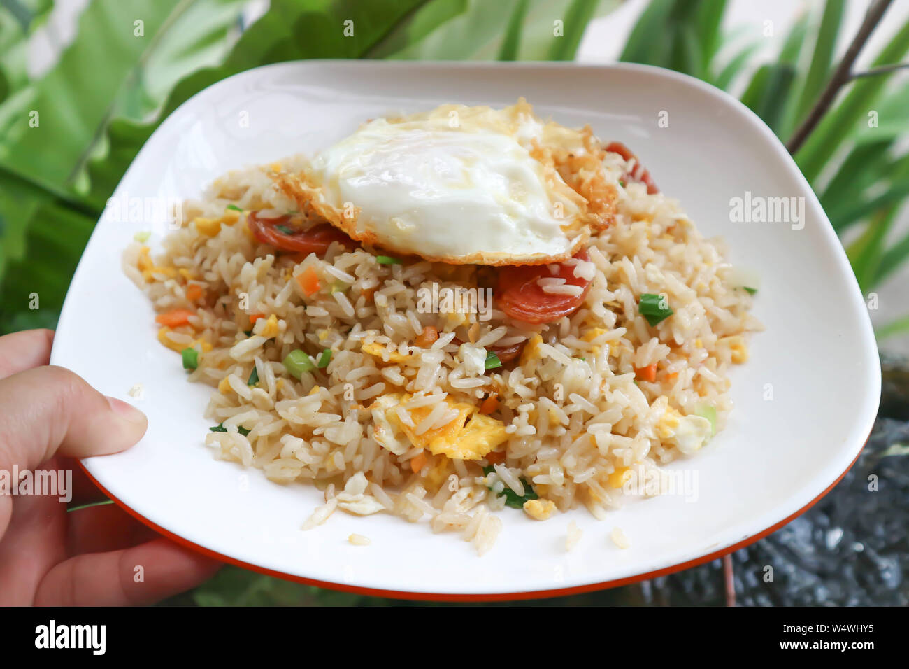 stir-fried rice with deep fried sausage ,egg and vegetable Stock Photo