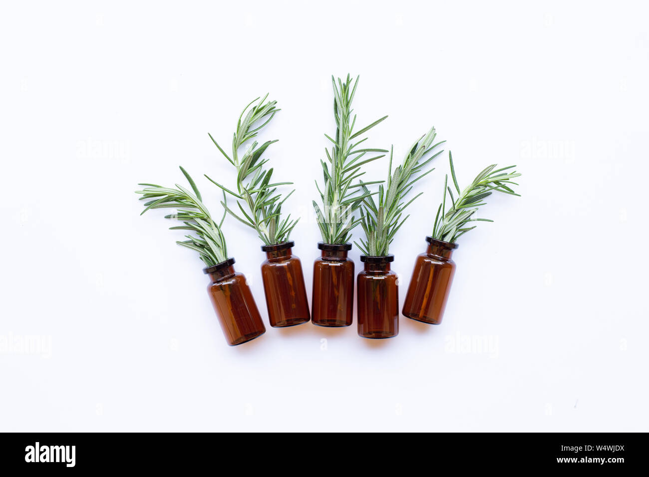 Bottle of essential oil with rosemary on white background Stock Photo ...