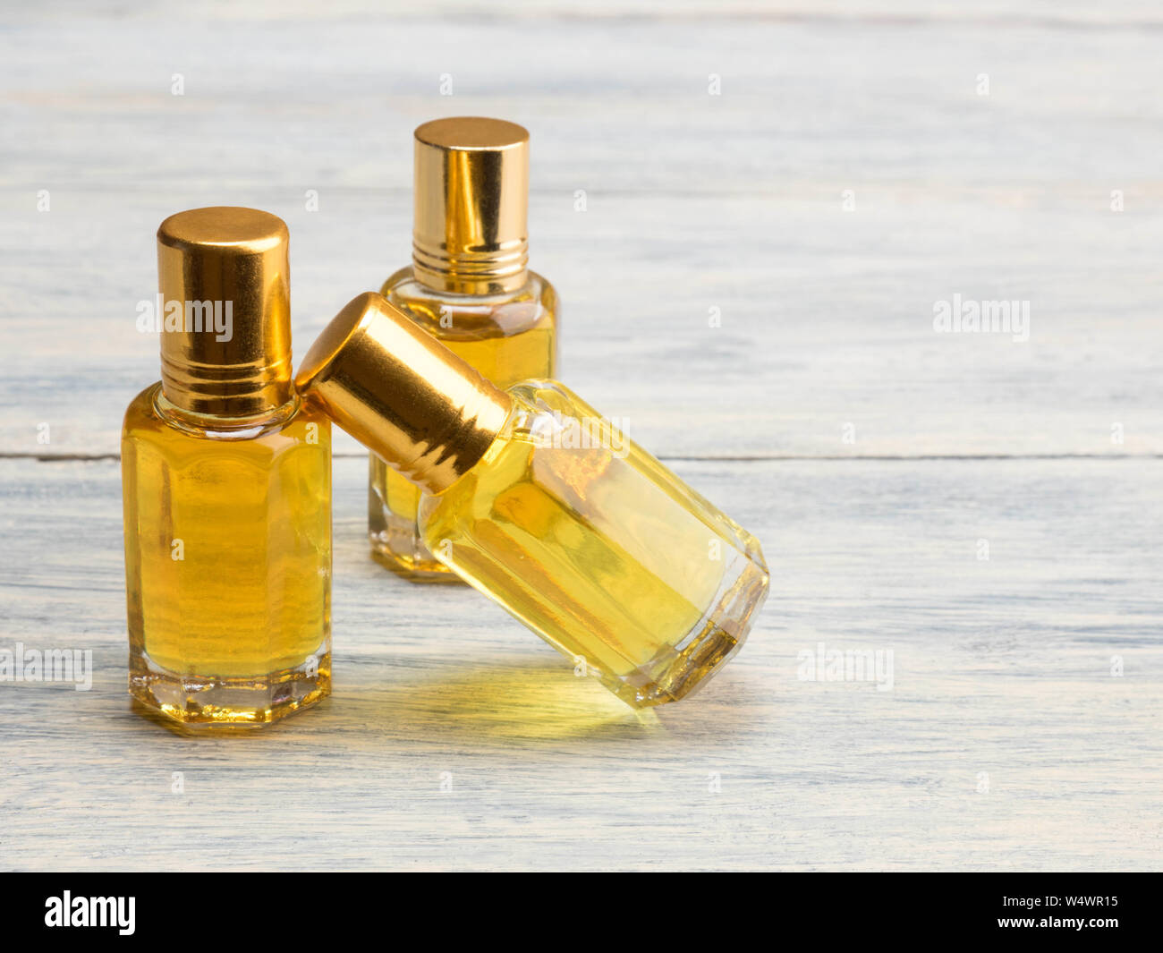 Three bubble with yellow natural aroma oil on white wooden background Stock Photo