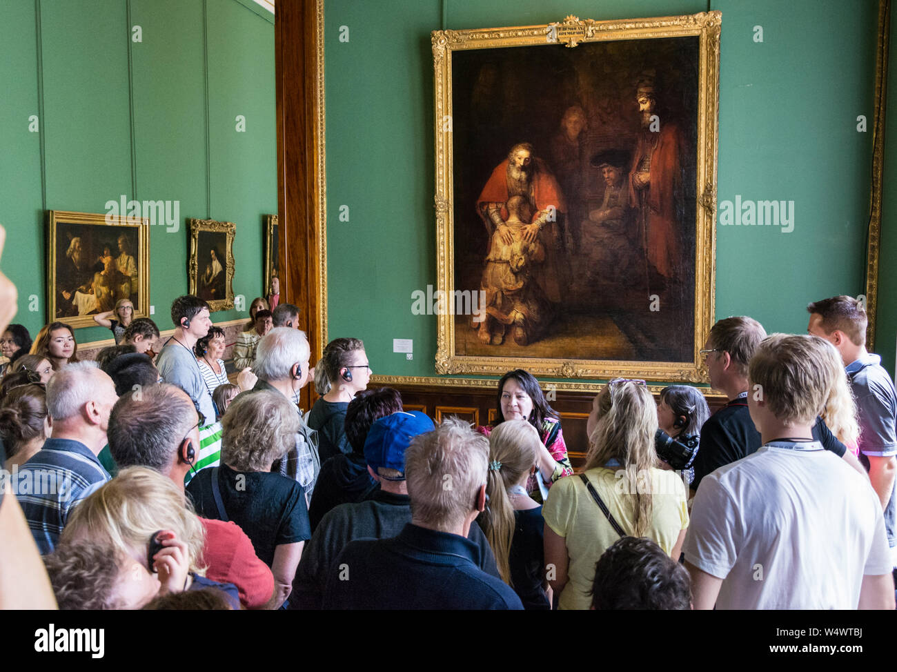 ST. PETERSBURG, RUSSIA - JULY 12, 2016: Visitors admire paintings by Rembrandt, 'The Return of the Prodigal Son' Stock Photo